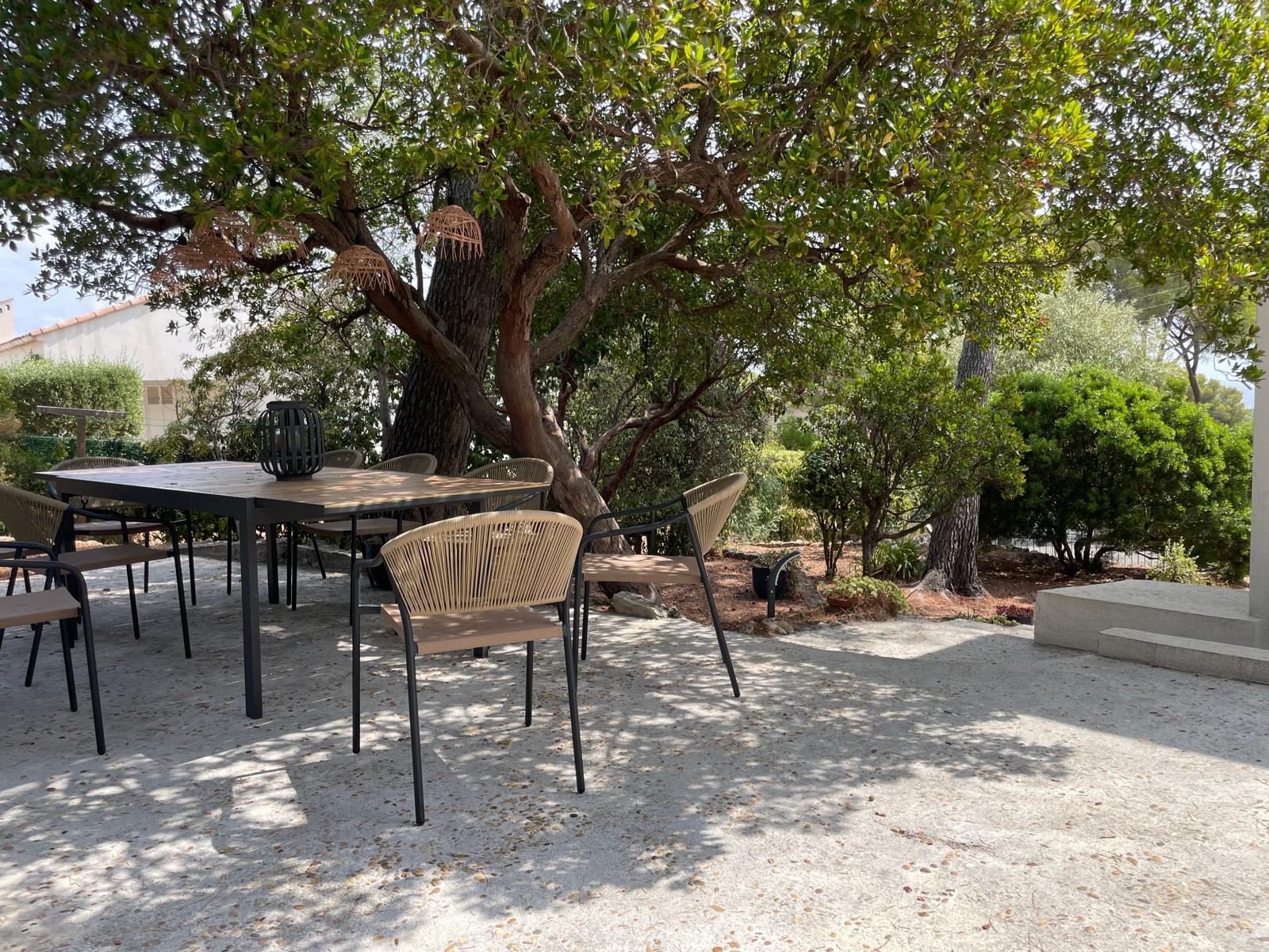 Outdoor dining table set for lunch in the shade