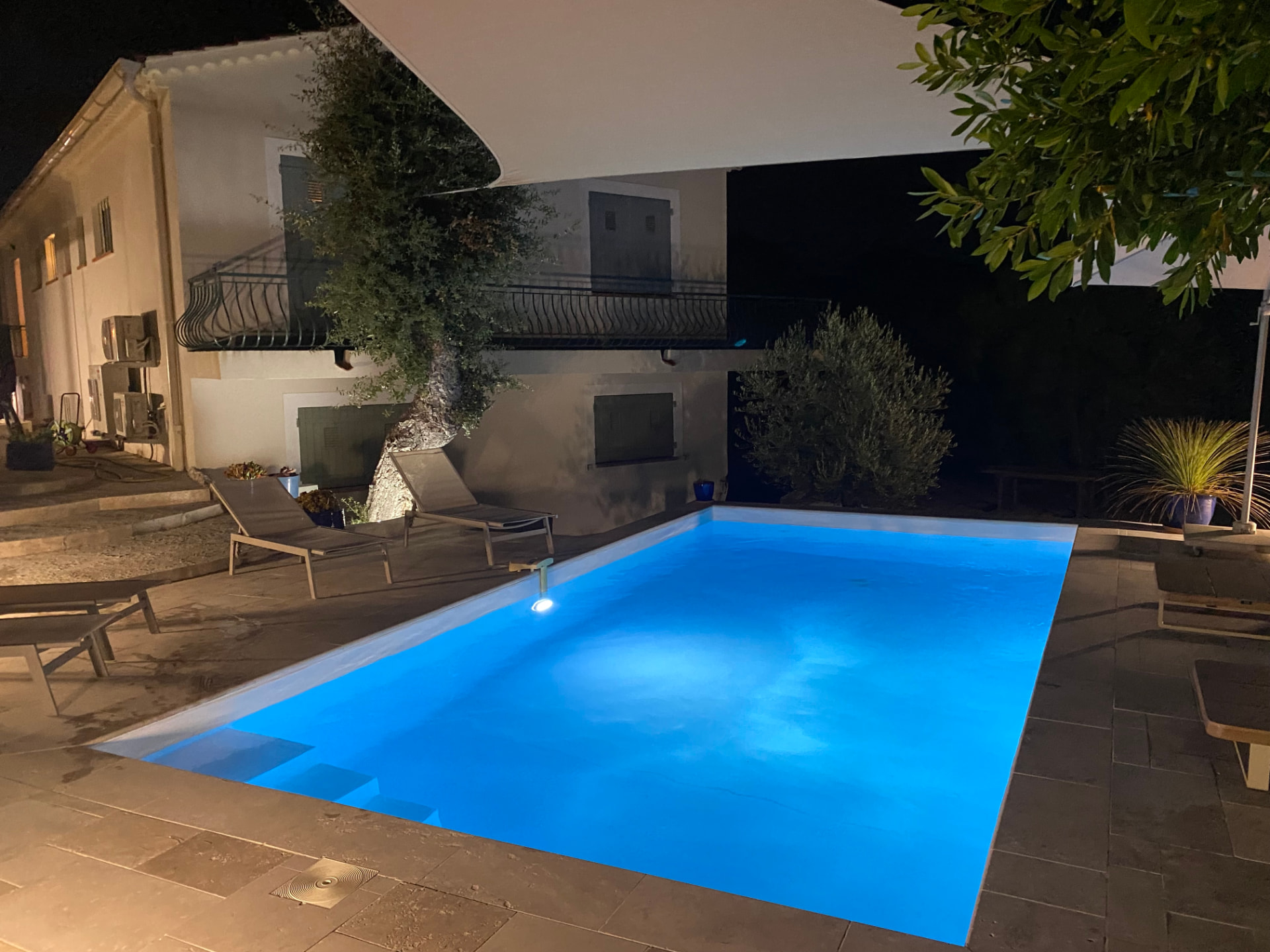 The swimming pool lit up in blue after dark