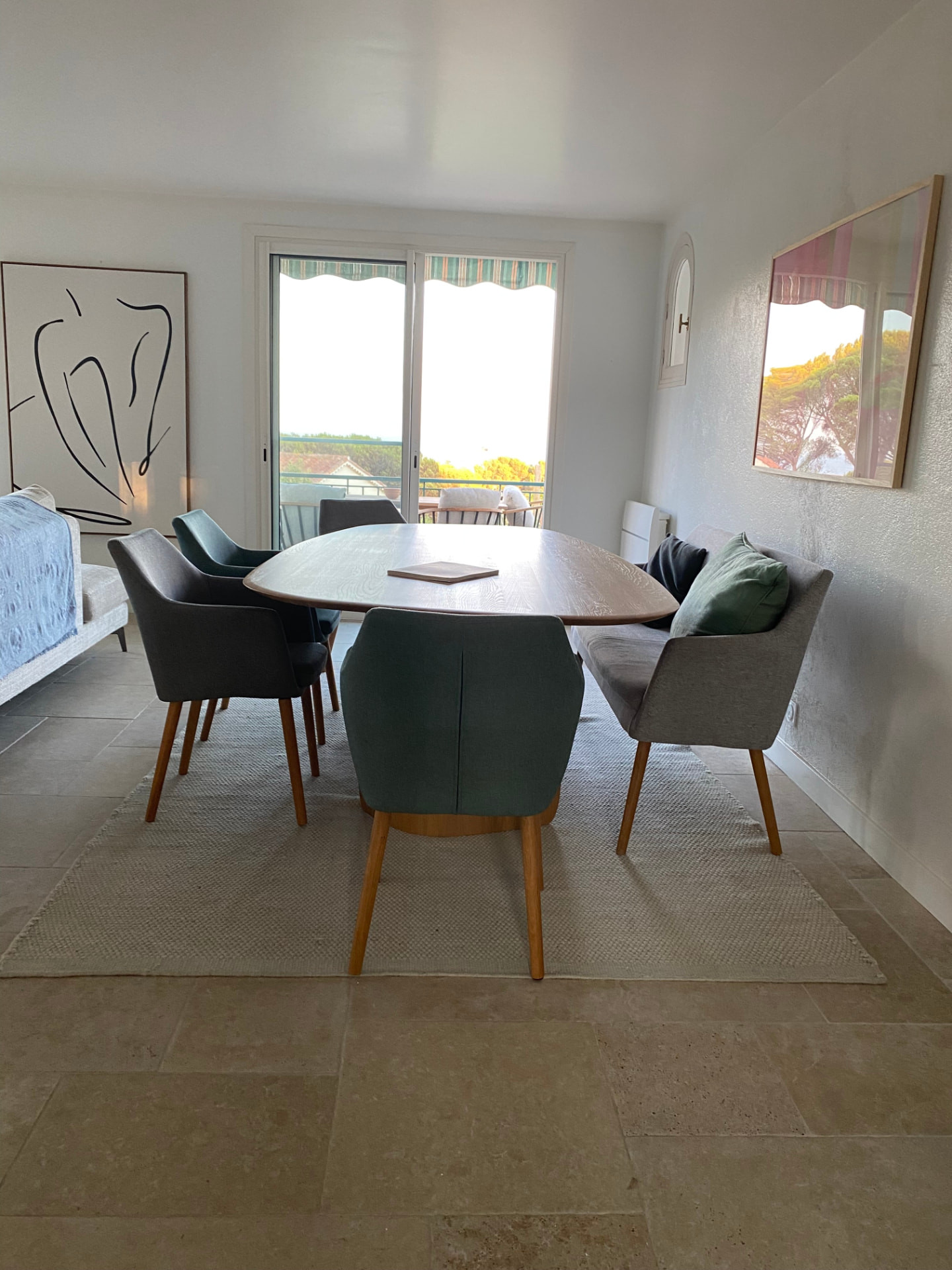 Indoor dining area with an oval table and blue chairs