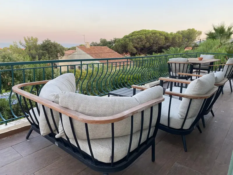 The main terrace at dusk with views over the bay of Saint-Aygulf